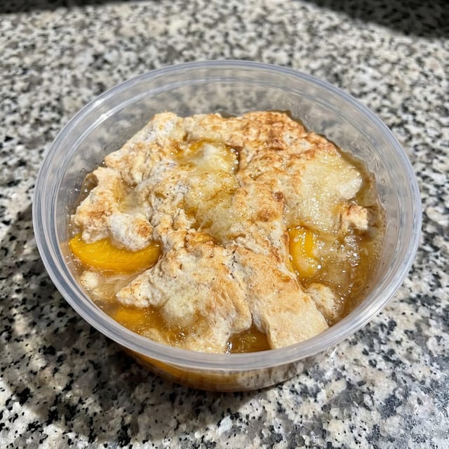 Peach Cobbler With One Scoop Ice Cream.